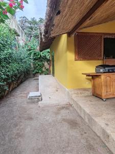 a yellow building with a counter and a desk at Keur Teranga Nianing in Nianing
