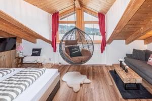 a room with a bed and a hanging swing at Bienenhaus #Bergblick im Sonnenhof in Seeg