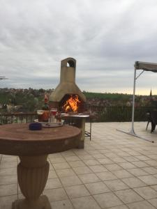 a pizza oven sitting on top of a patio at La Maison des Pierres in Zinswiller