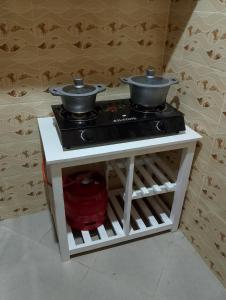 a stove with two pots on top of it at Lucy Chwada hostel in Watamu