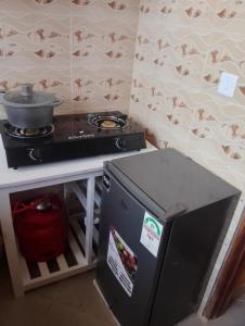 a kitchen with a stove and a counter top at Lucy Chwada hostel in Watamu +10 photos