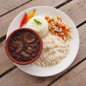 a plate of food with rice and a bowl of soup at Suite na Natureza com Café da Manhã in São Pedro
