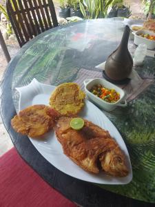 a plate of food on a glass table at hostal el gato in Utica