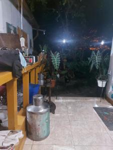 a pot sitting on the floor next to a table with plants at hostal el gato in Utica +1 photo