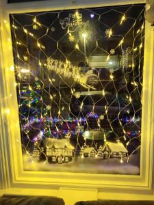 a window with christmas lights in a room at MyRoomz Tudor Rose Original in Blackpool