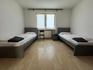 a room with two beds and a window at Tulpen Residenz in Offenbach