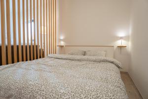 a bedroom with a white bed with two pillows at Studio apartman LuG in Ravna Gora