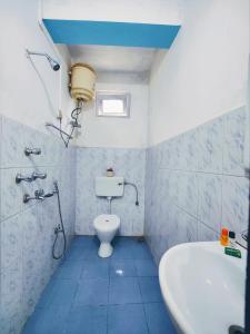 a bathroom with a toilet and a sink and a tub at Jo'stel Hotel Winter Green- MG Marg in Gangtok