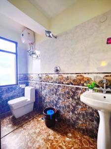 a bathroom with a sink and a toilet at Jo'stel Hotel Winter Green- MG Marg in Gangtok +23 photos
