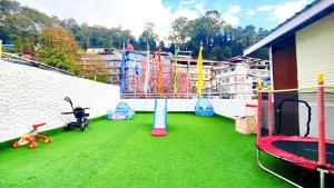 a play area with a playground with green grass at Jo'stel Hotel Winter Green- MG Marg in Gangtok