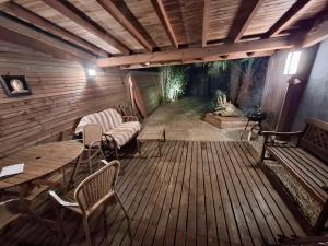 a large wooden deck with a large aquarium in the background at Aux portes de l ocean in Labenne