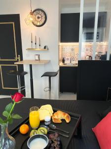 a table with a tray of breakfast food on it at La Suite Nocturne in Fère-en-Tardenois