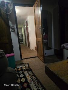 een gang met een deur die naar een slaapkamer leidt bij The grand in Nag` el-Ramla