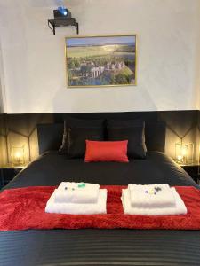 a bedroom with a bed with two towels on it at La Suite Nocturne in Fère-en-Tardenois +47 photos