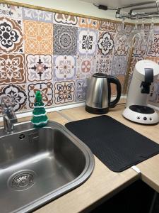 a kitchen counter with a sink and a coffee maker at La Suite Nocturne in Fère-en-Tardenois
