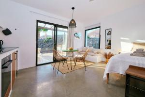 Un dormitorio con una cama y una mesa y sillas. en Casa del Aljibe - El Estudio, en La Asomada