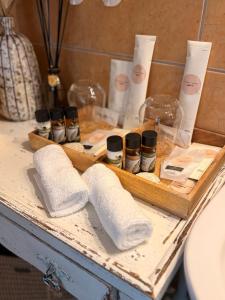 a wooden tray with towels and other products on a table at Kis házikó vendégház in Pécsvárad