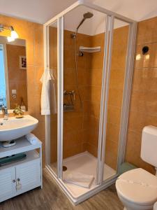 a bathroom with a shower and a sink at Kis házikó vendégház in Pécsvárad +78 photos