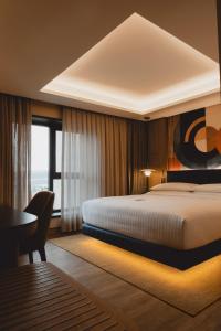 a hotel room with a bed and a desk at Delta Hotels by Marriott Istanbul Karakoy in Istanbul