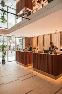 a lobby of a restaurant with people sitting at desks at Delta Hotels by Marriott Istanbul Karakoy in Istanbul