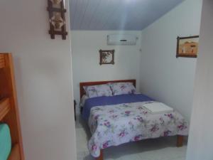 a bedroom with a bed with a book on it at Pousada Castelo do Gaúcho in Baía Formosa +13 photos