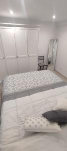 a bedroom with a large white bed in a room at Casa de poble Cal Casellas in San Martín Sasgayolas