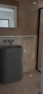 a bathroom with a sink and a mirror at Pacific Sun Bargara in Bargara