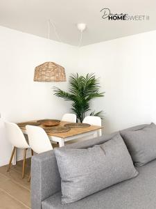 a living room with a couch and a table at Oasis Dunas Sweet Family Home II Pool view by B-Rent in Corralejo