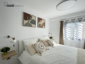a white bedroom with a white bed with pillows at Oasis Dunas Sweet Family Home II Pool view by B-Rent in Corralejo +36 photos