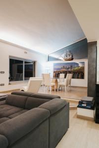 a living room with a couch and a table at Artemide Resort Spa - Private Villa in Lido Di Fondi