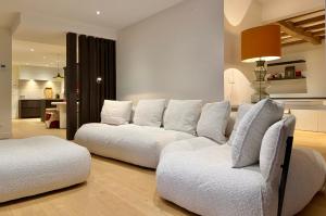a living room with a white couch and a chair at exceptional luxury villa near Knokke Golf in Knokke-Heist