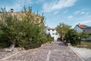 a cobblestone street in front of a white building at Borgo del Piano "Alloggio Emilia" in Rapino +15 photos