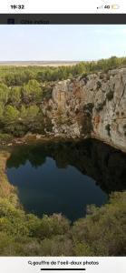 a picture of a lake in front of a cliff at L'horizon De Coursan in Coursan
