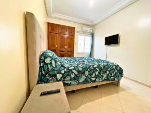 a bedroom with a bed with a couch and a table at 2 BR apartment - City Center Residency - Panoramic City Views - 3 Min Train Access by ZenStay in Fès