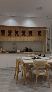 une cuisine avec une table et des chaises dans une cuisine dans l'établissement Arjola Cozy Stay, à Korçë 23 autres photos