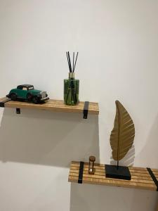a shelf with a toy car and a plant on it at L'horizon De Coursan in Coursan