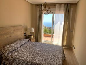 Un dormitorio con una cama y vista al mar. en Piso 3 dormitorios en Isla del Fraile Golf Resort con espectaculares vistas, en Águilas