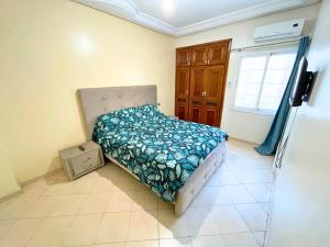 a small bedroom with a bed in a room at 2 BR apartment - City Center Residency - Panoramic City Views - 3 Min Train Access by ZenStay in Fès
