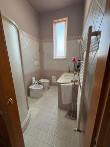 a bathroom with a toilet and a sink and a tub at LillaBloom in Nocera Inferiore +20 photos