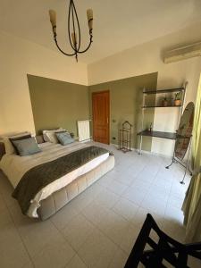 a bedroom with a large bed and a chandelier at LillaBloom in Nocera Inferiore