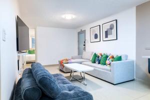 a living room with a couch and a table at Aquaville Dorado Moderna Villa 5 in Dorado +45 photos