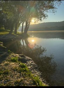 a river with the sun reflecting in the water at Apartament cu 1 camera in Soroca