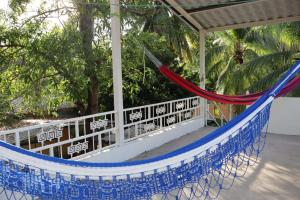 a hammock on the porch of a house at Costabay in El Zapote