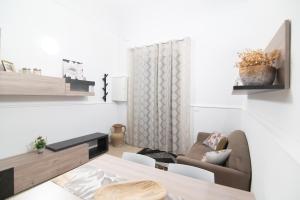 a living room with a couch and a table at Dimora Saracena in Adrano