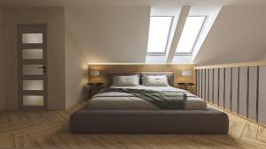 a bedroom with a large bed with two windows at Aqua & Wellness resort Alzbeta in Liptovský Mikuláš