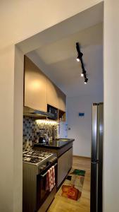 a kitchen with a stove and a refrigerator at Mimi homes in Tatu City