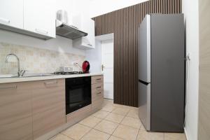 a kitchen with a refrigerator and a sink at Dimora Saracena in Adrano +44 photos