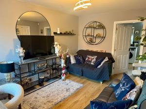 a living room with a couch and a large mirror at Willow Cottage in North Muskham