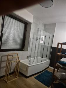 a bathroom with a bath tub and a window at Appartment Rheinaue in Duisburg +27 photos