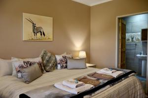 a bedroom with a bed with towels on it at Uitvlugt Ponds in Dullstroom